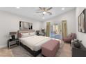 Relaxing bedroom features a walkout patio, neutral tones, and a comfortable bed for a serene retreat at 10955 Sospel Pl, Las Vegas, NV 89141