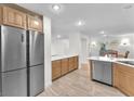 Modern kitchen with stainless steel appliances, light wood cabinets, and an open layout, perfect for entertaining and culinary enthusiasts at 10955 Sospel Pl, Las Vegas, NV 89141