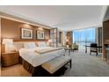 A contemporary bedroom suite features a seating area, and floor to ceiling windows at 135 E Harmon Ave # 405, Las Vegas, NV 89109
