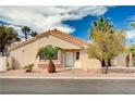 Charming single-story home with a white front door, well-kept yard, and mature palm trees at 1645 Indian Cove Ln, Las Vegas, NV 89128