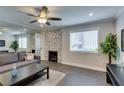 Cozy living room with fireplace, a modern ceiling fan, and plenty of natural light at 1701 E Katie Ave # 51, Las Vegas, NV 89119