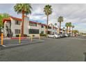Well-maintained condo building with mature palm trees and ample parking at 1701 E Katie Ave # 68, Las Vegas, NV 89119