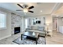 Comfortable living room featuring a modern stone fireplace, ceiling fan, area rug, and view of an outdoor area at 1701 E Katie Ave # 9, Las Vegas, NV 89119