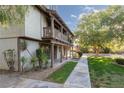 Charming townhome with an upper balcony, cozy front porch, and landscaped yard under blue skies at 3189 Pinehurst Dr # B, Las Vegas, NV 89109