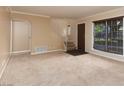Beige living room with neutral carpet, stairwell and large window with natural light at 3189 Pinehurst Dr # B, Las Vegas, NV 89109
