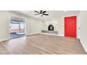 Spacious living room with a sliding glass door, fireplace, and light wood floors, bathed in natural light at 3212 Hickey Ave, North Las Vegas, NV 89030