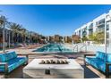 Inviting pool area with lounge chairs and a modern fire pit, perfect for outdoor relaxation at 353 E Bonneville Ave # 289, Las Vegas, NV 89101