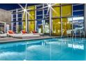 Rooftop pool area with stylish seating and vibrant city lights for nighttime relaxation at 3726 S Las Vegas Blvd # 1003, Las Vegas, NV 89158