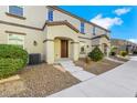 Inviting townhome boasts low-maintenance desert landscaping and a private covered entryway at 4561 Woolcomber St, Las Vegas, NV 89115