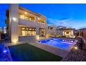 Backyard showcasing a modern house with a sparkling pool and outdoor bar area at 5231 Iron River Ct, Las Vegas, NV 89135
