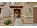 Welcoming front entrance with a covered porch and attractive landscaping at 6470 Little Harbor Ct, Las Vegas, NV 89141