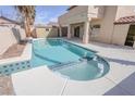 Relaxing backyard pool with attached spa and easy access to covered patio at 6586 Mount Roy Ln, Las Vegas, NV 89156
