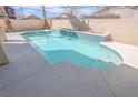 Sparkling backyard pool with a spa, steps and decorative tile; perfect for cooling off at 6586 Mount Roy Ln, Las Vegas, NV 89156