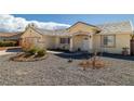 Cozy front entrance featuring low maintenance landscaping, chairs, and covered porch at 6751 Stubblefield Dr, Pahrump, NV 89061