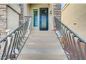 Close-up of a staircase leading to an ornate front door with decorative glass and metal railings at 6773 Goose Watch Ct, Las Vegas, NV 89139