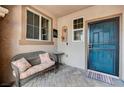 Inviting front porch featuring a cozy bench, stylish decor, and a secure front door at 6929 Benson Ferry St, Las Vegas, NV 89149