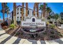 Community sign for Mission Ridge Condominiums, surrounded by lush landscaping at 700 Carnegie St # 3214, Henderson, NV 89052