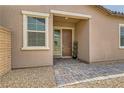 Welcoming front entrance features a covered porch, beautiful door, and lovely landscaping at 728 Omaggio Pl, Henderson, NV 89011
