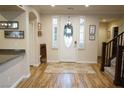 Bright foyer with wood floors, a decorative rug, and an elegant front door at 8224 Opal Falls St, North Las Vegas, NV 89085