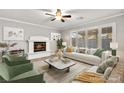 Cozy living room with a fireplace, comfortable seating, and bright windows at 8528 Sierra Cima Ln, Las Vegas, NV 89128