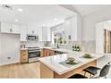 Well-lit kitchen boasts quartz counters, stainless appliances, tile backsplash, and breakfast bar at , Las Vegas, NV 89134