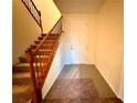 Inviting entryway with a tiled floor, staircase, and a bright white front door at 10145 White Mulberry Dr, Las Vegas, NV 89148