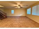 Bright and airy living area with ample natural light, carpet, and ceiling fan at 10145 White Mulberry Dr, Las Vegas, NV 89148