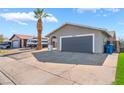 Exterior view of a home with a concrete driveway leading to a two-car garage at 1437 Price St, Henderson, NV 89011