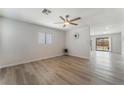 Bright living room with hardwood floors, ceiling fan, and a view into the backyard at 1437 Price St, Henderson, NV 89011