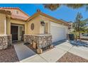 Charming single story home featuring stone accents and a two car garage at 1708 Gentle Brook Ave, Las Vegas, NV 89084