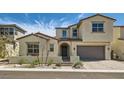 Charming two-story home with a stucco exterior, arched entryway, and well-manicured front yard at 182 Robledo St, Las Vegas, NV 89138