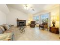 Cozy living room with a stone fireplace, comfortable seating, and a large window at 2040 Tucuman Ave, Pahrump, NV 89048