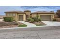 Charming single-story home features a tile roof, desert landscape and two-car garage at 2116 Burtonsville Dr, Henderson, NV 89044