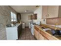 Functional kitchen with tile flooring and essential appliances at 2125 Flower Ave, North Las Vegas, NV 89030