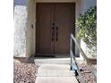 The front entrance has stately brown double doors and a secure handrail at 2569 Malabar Ave, Las Vegas, NV 89121