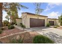 Charming home featuring a well-maintained exterior with a two-car garage and desert landscaping at 2569 Malabar Ave, Las Vegas, NV 89121