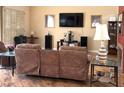 Living room featuring recliner seating, entertainment center, and hardwood flooring at 2569 Malabar Ave, Las Vegas, NV 89121