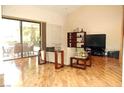 Bright living room with hardwood floors and sliding glass doors that open to the patio at 2569 Malabar Ave, Las Vegas, NV 89121