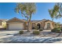 Charming single-story house with mature trees, desert landscaping, and a two-car garage at 3017 Walnut Park Ct, Henderson, NV 89052
