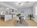 Bright dining area with modern lighting and a view into the stylish kitchen at 3611 Valencia St, Las Vegas, NV 89121