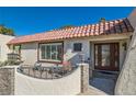 Inviting front entrance featuring a terra cotta roof, a seating area, and a decorative glass door at 3788 Forestcrest Dr, Las Vegas, NV 89121