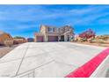 Attractive two-story home featuring a three-car garage and large concrete driveway at 3809 Vincelli Ave, North Las Vegas, NV 89031