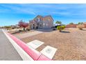 Beautiful home featuring desert landscaping, a brick walkway and charming curb appeal at 3809 Vincelli Ave, North Las Vegas, NV 89031