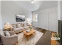 Inviting, virtually staged living room featuring neutral tones, plush furnishings, and bright, natural light at 3829 Soda Springs Dr, Las Vegas, NV 89115