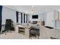 Bright, spacious living room with tile floors, blue drapes, modern lighting, and comfortable seating at 3920 Sweet Pine St # 102, Las Vegas, NV 89108
