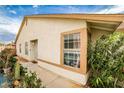 Beige single-story home featuring a garden, windows, and a sidewalk at 4438 Faberge Ave, Las Vegas, NV 89115