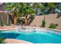 Gorgeous backyard pool with a spa, complemented by well-maintained landscaping and privacy walls at 4574 Sheri Lyn Ct, Las Vegas, NV 89121