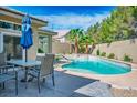 Beautiful backyard pool and patio area, complete with outdoor dining and a tranquil ambiance at 4574 Sheri Lyn Ct, Las Vegas, NV 89121