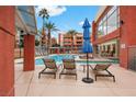 A beautiful in-ground community pool with plenty of lounging chairs, umbrellas and seating, as well as nice palm trees at 51 E Agate Ave # 507, Las Vegas, NV 89123