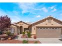 Front exterior view of a single-story home with desert landscaping and a two-car garage at 5433 Honey Mesquite Ln, Las Vegas, NV 89130